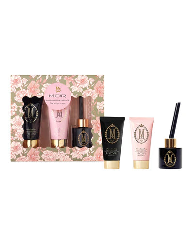 A gift set including a MOR marshmallow-themed body wash, body milk, and reed diffuser, packaged in a box with floral patterns.