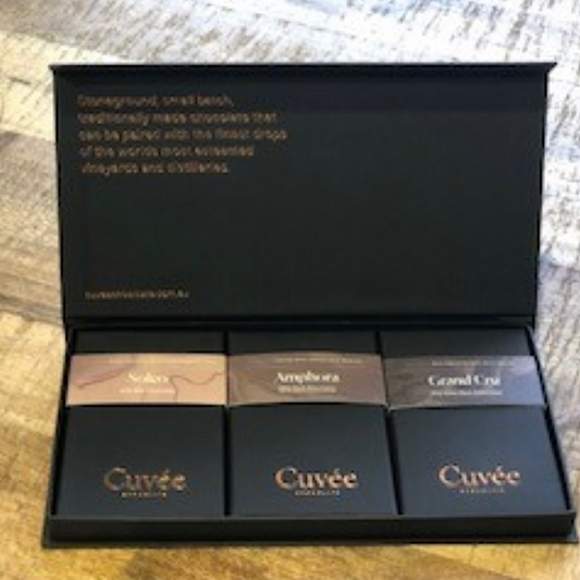 A chocolate gift box by Cuvee, containing three different types of chocolate, with the brand name and flavors visible on the packaging.