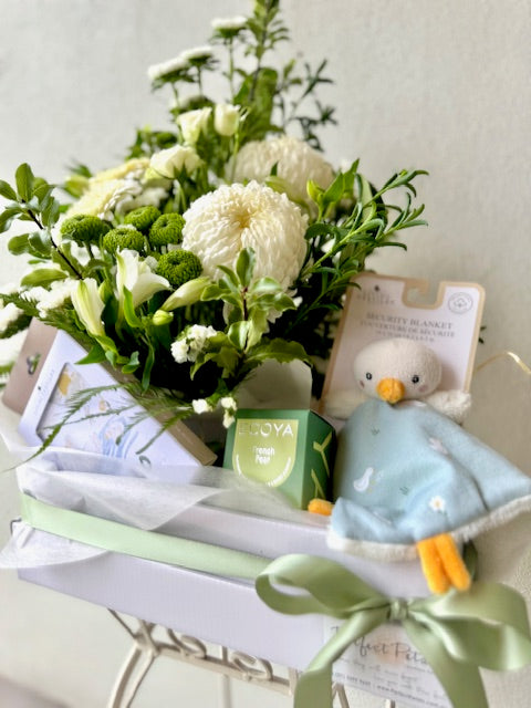 Newborn baby gift hamper with fresh floral arrangement of white flowers, Living Textiles Duck baby blanket, milestone cards and Ecoya candle.