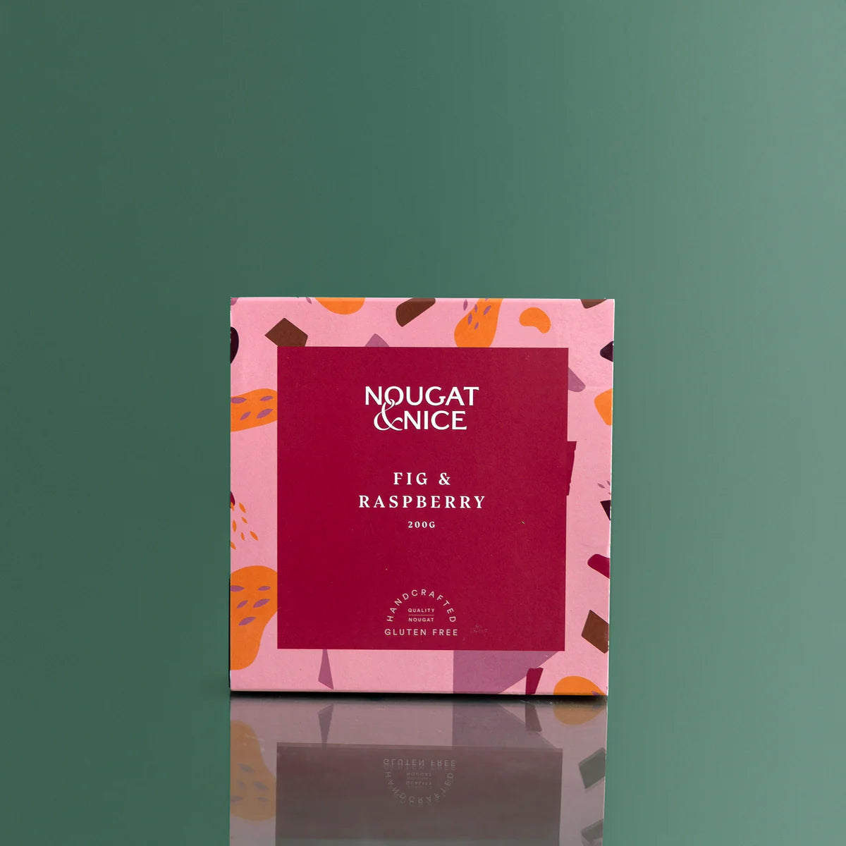 Nougat & Nice fig and raspberry nougat packaging on a green background