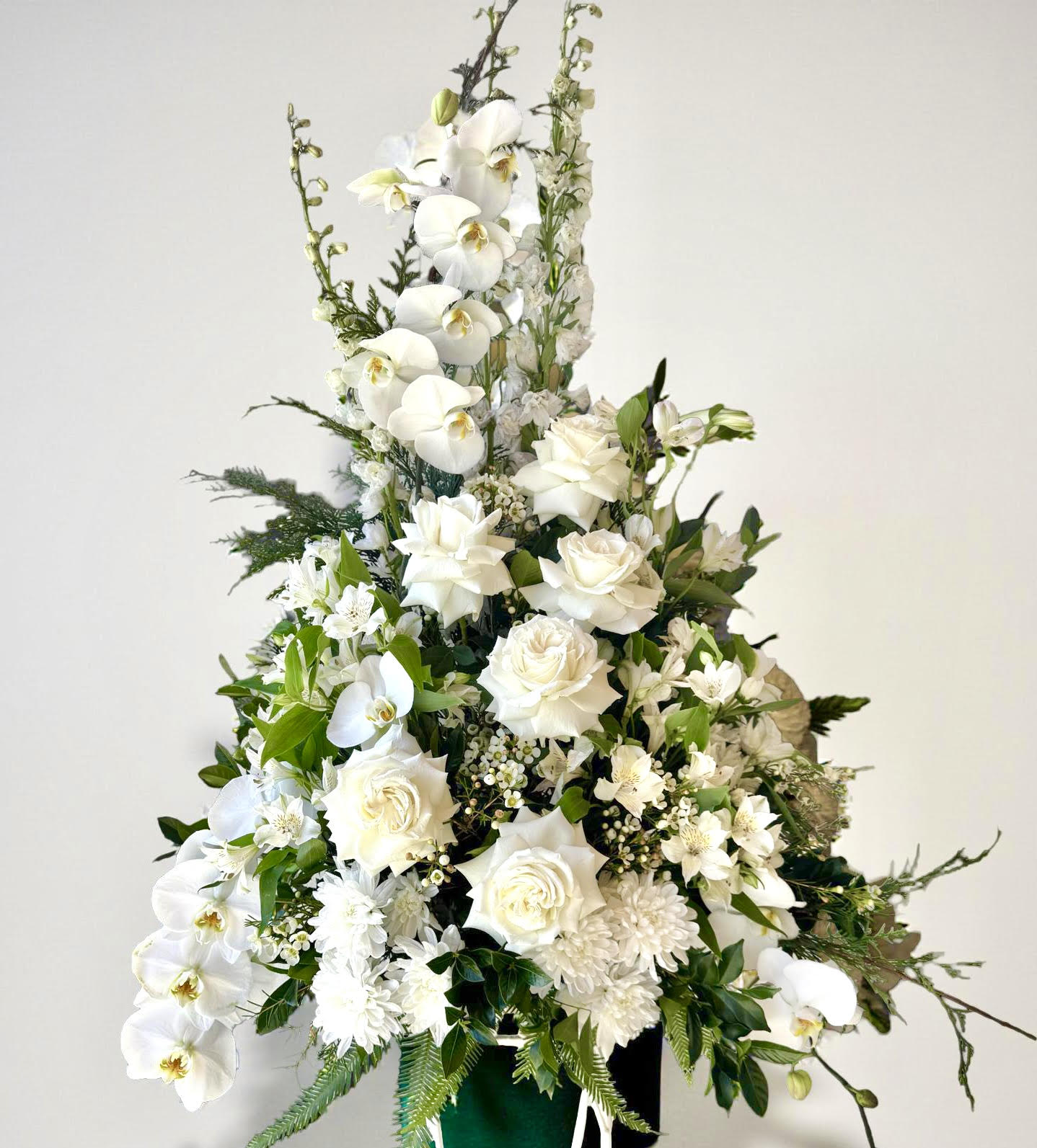 Tall white orchid and rose event floral arrangement in pedestal style