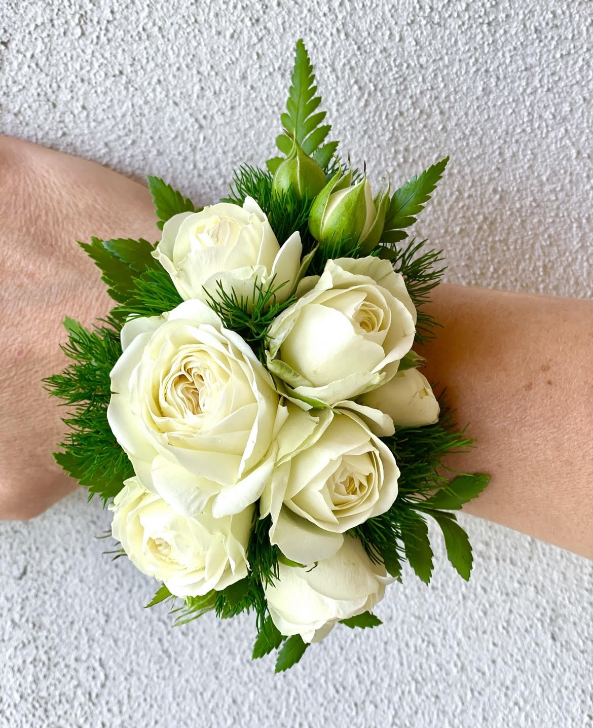 Wrist corsage of white spray roses