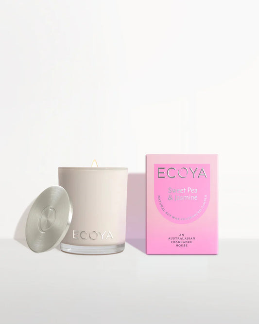 An Ecoya Mini Madison Candle in a beige glass jar with a silver lid, accompanied by a pink box with the Ecoya brand and product information.