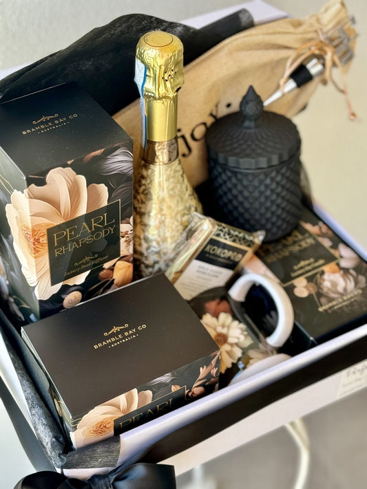 premium gift hamper of wine, scented candle, diffuser, matching mug and chocolates