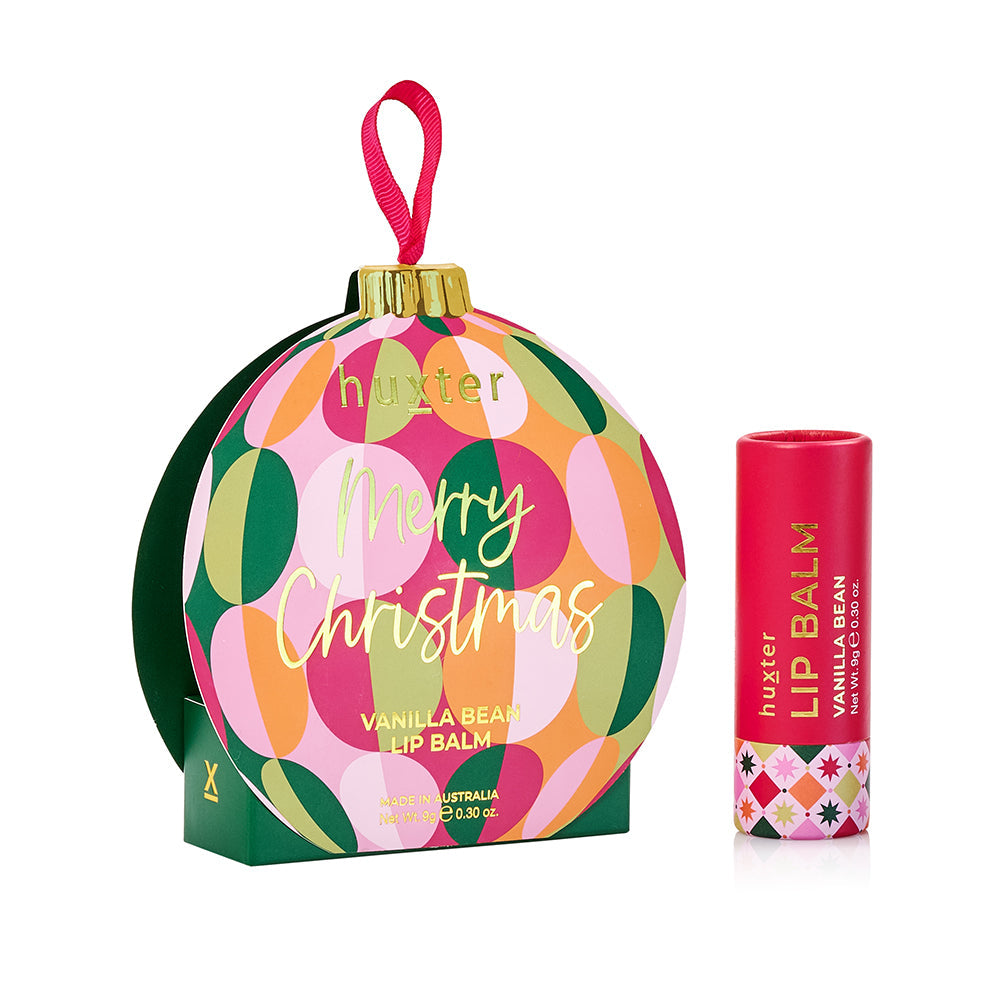 Huxter Vanilla Bean lip balm with its green circle patterned Merry Christmas bauble gift box