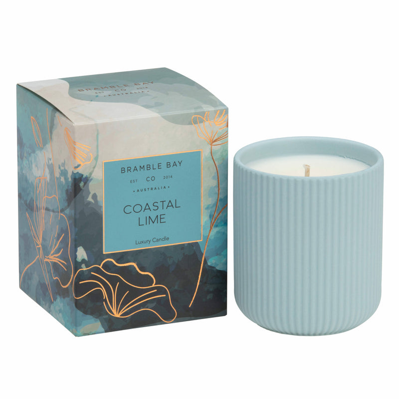 A Bramble Bay Co Coastal Lime  ceramic candle with a blue lid and a label that reads 'Bramble Bay Co Australian Native Collection Coastal Lime'. The packaging is also shown with a floral design.