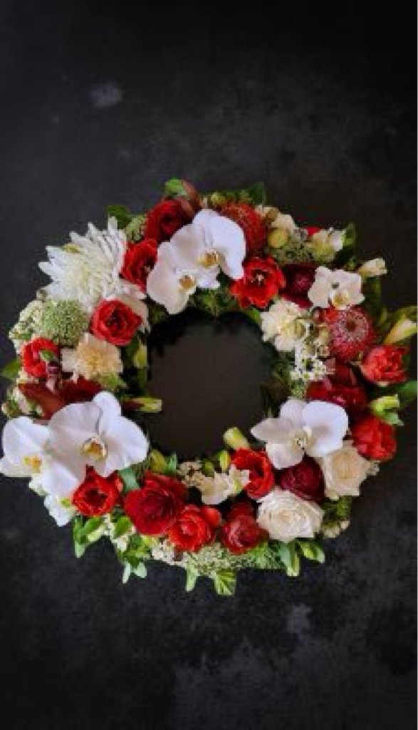 sympathy wreath of red and white flowers