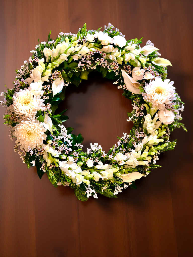 sympathy wreath with soft pastel flowers