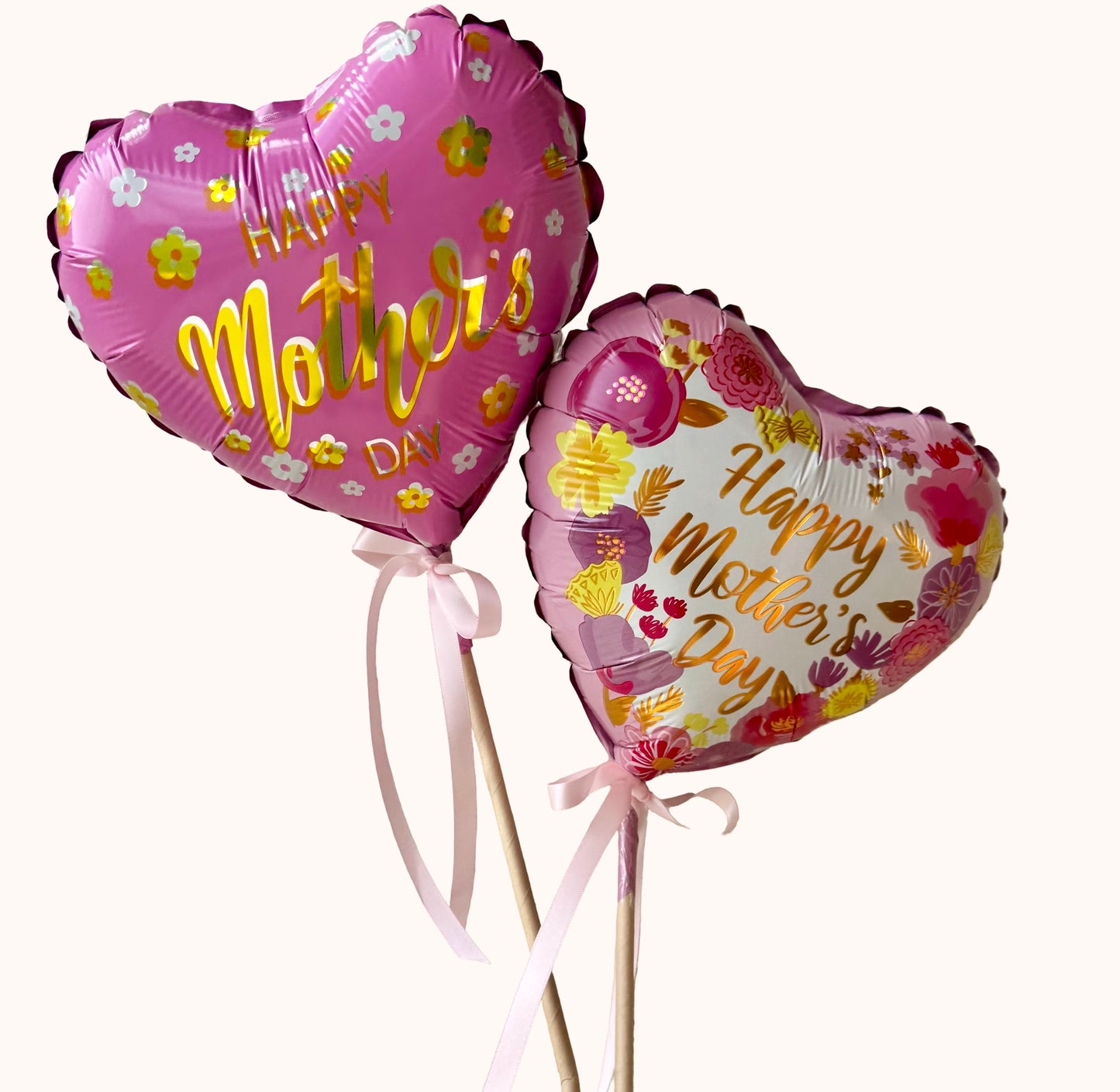 Air-filled Happy Mother’s Day heart balloons on sticks with pink ribbon, perfect add-on gift for Mother’s Day flower delivery