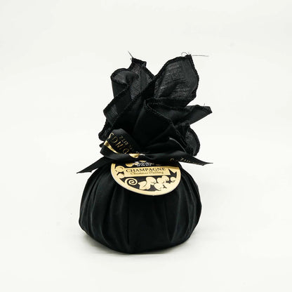 Black silk bag of Christmas Pudding with a gold label on a white background