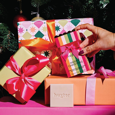 Huxter striped Christmas bon bon soaps with wrapped presents and a Christmas tree