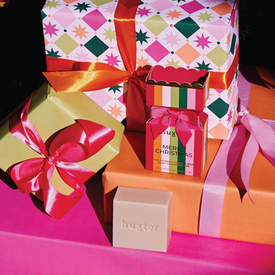 Huxter mulberry striped bon bon soap stacked with festive gift boxes