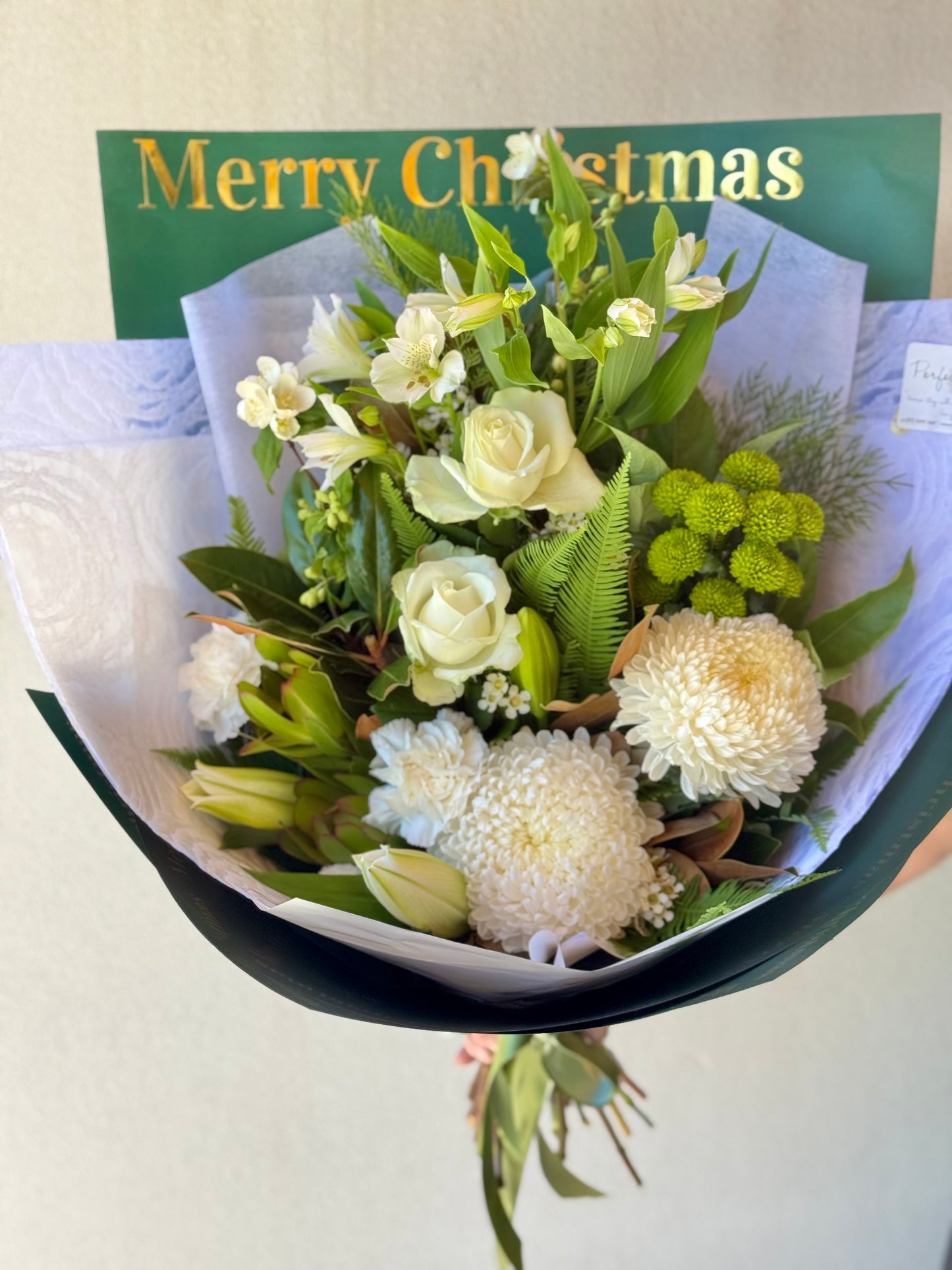 Luxe white flower Christmas bouquet including roses, and lilies