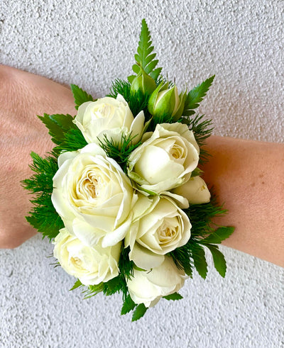 Wrist corsage of white spray roses