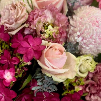 Pretty in Pinks floral arrangement featuring feminine pink seasonal blooms in a premium Perfect Petals style