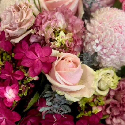 Pretty in Pinks floral arrangement featuring feminine pink seasonal blooms in a premium Perfect Petals style